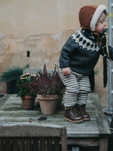 kids photography, kids photography ideas at home, boy in petit nord shoes next to flowers