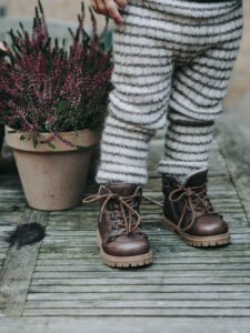 kids photography, kids photography ideas at home, boy in petit nord shoes next to flowers
