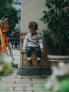kids photography, kids photography ideas at home, boy in petit nord shoes sitting on a chair outside