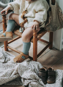 kids photography, kids photography ideas at home, boy wearing sandals by petit nord, sitting in a chair