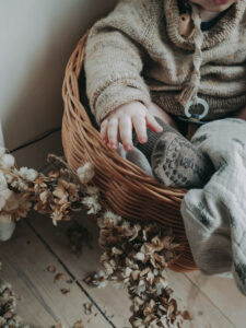 my boys wearing gobabygo socks sitting in a basket